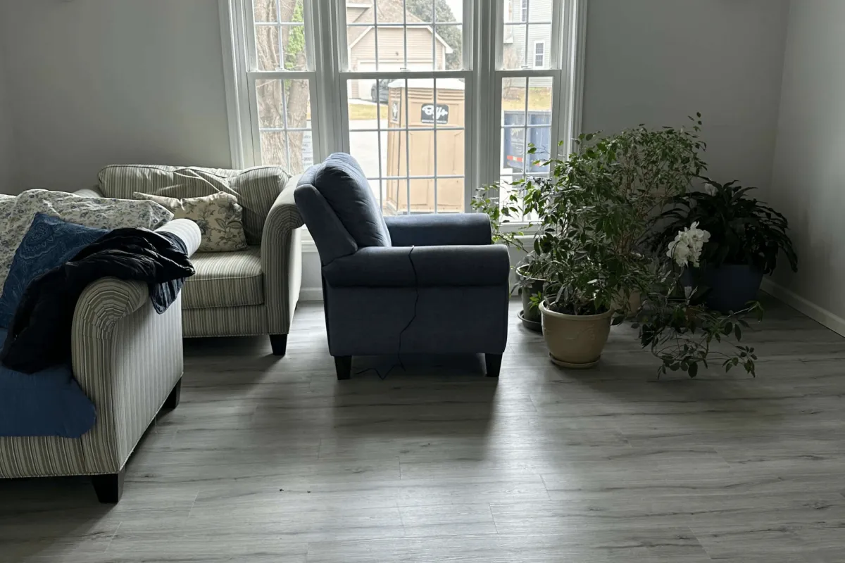 Modern dining and living area with large windows.