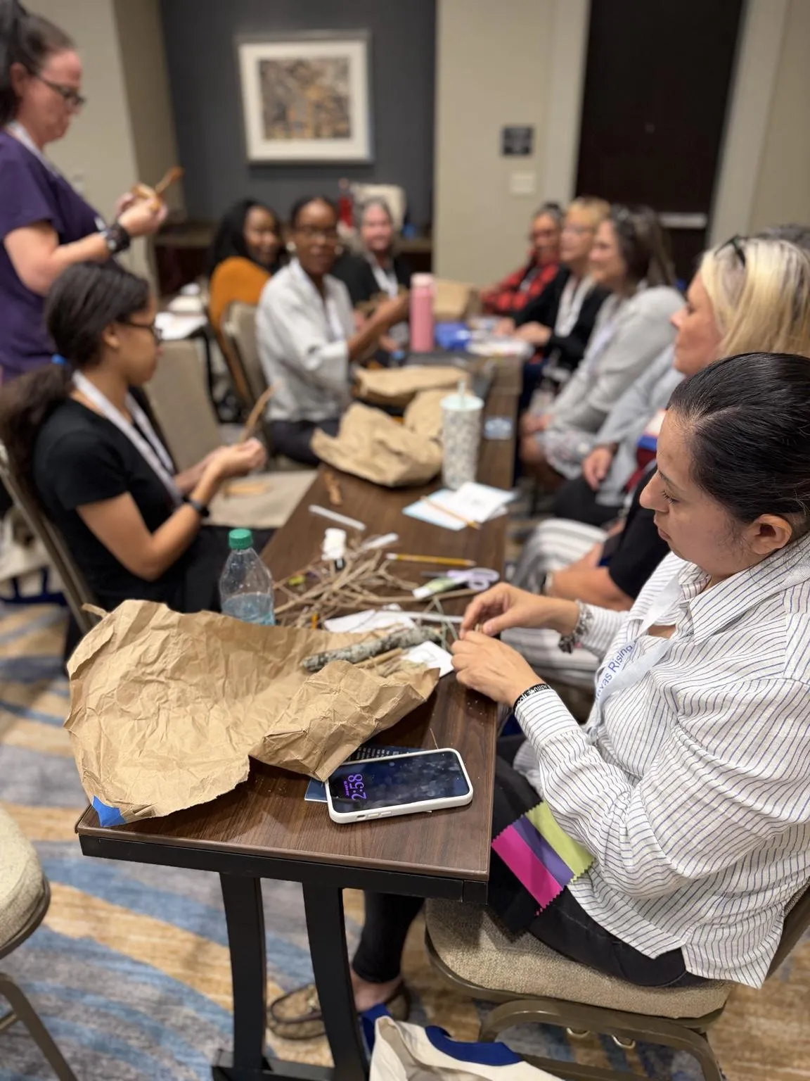 Educators creating art from natural materials at a workshop table