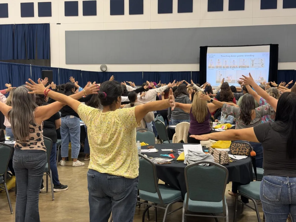 Educators stretching together during a yoga training
