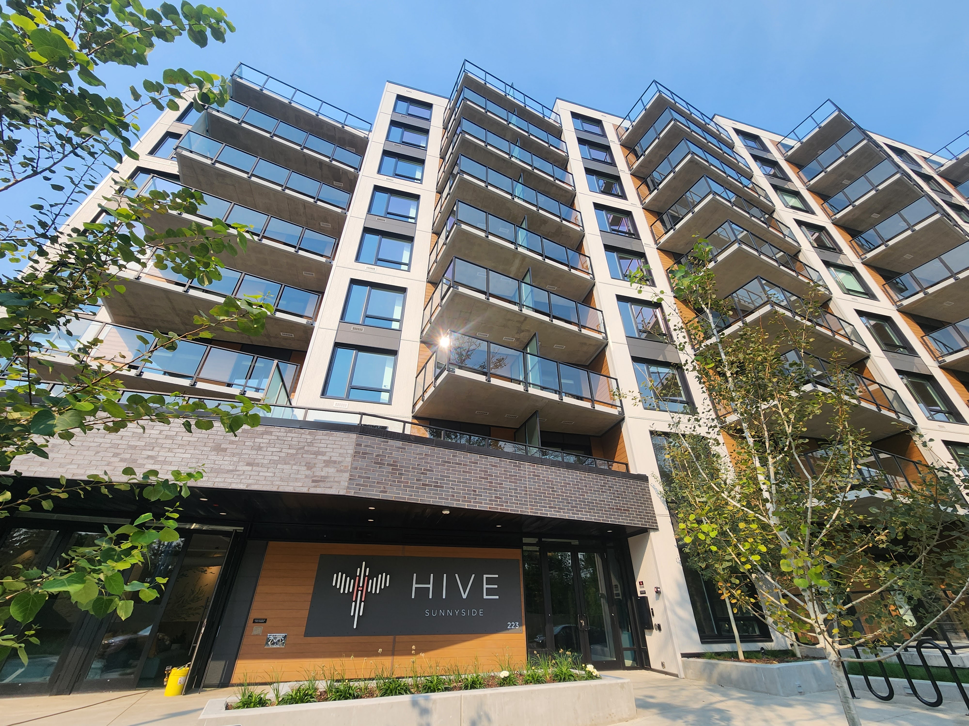 Mid-rise commercial building façade photograph showing ventilated rain-screen cladding in natural daylight, tight composition of elevation details, demonstrating jointing, texture, and installed profile performance.