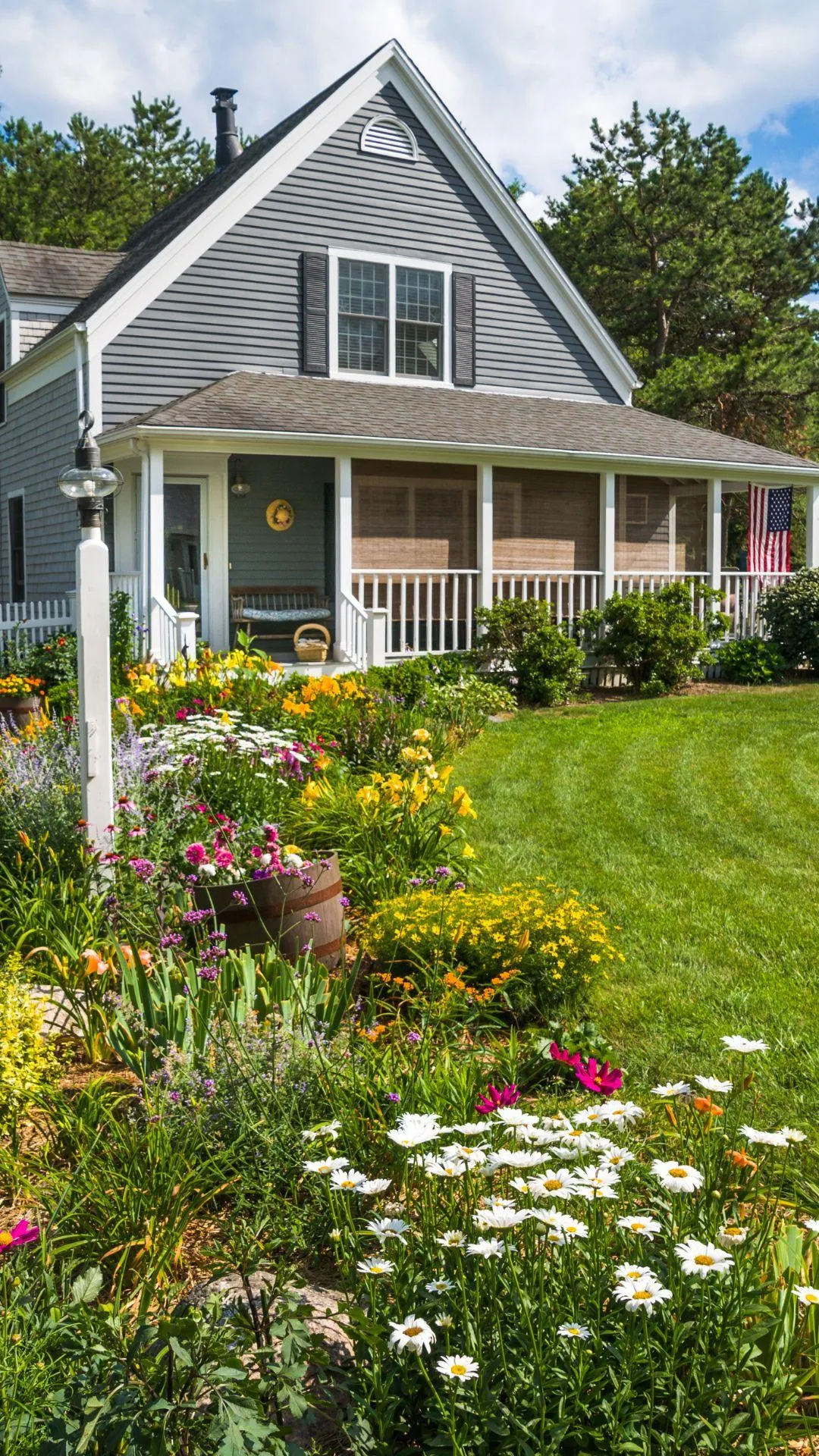 beautiful garden bed with lots of flowers outside a home