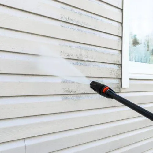 Pressure washing the side of a homes siding