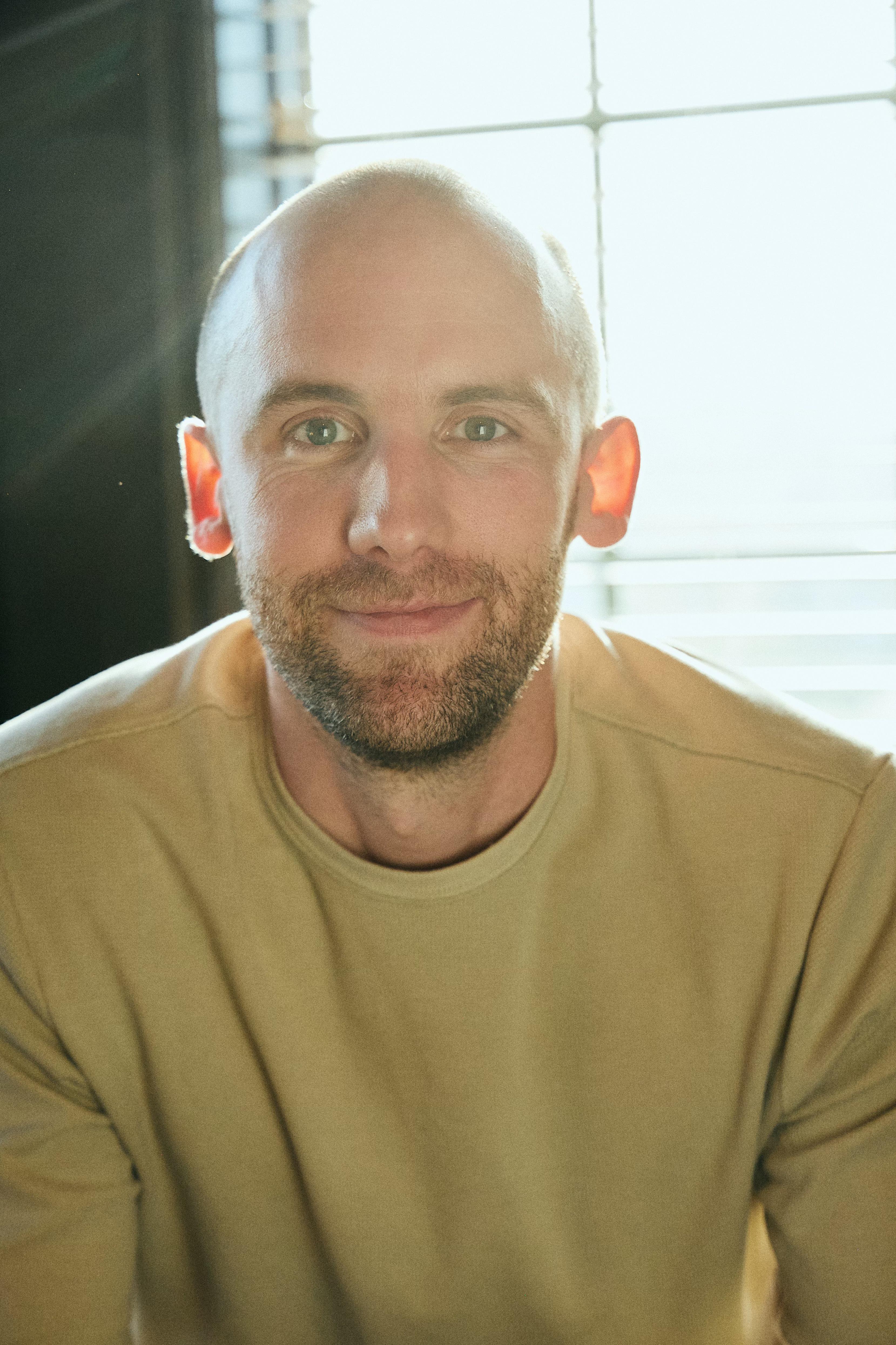 group of people sitting beside rectangular wooden table with laptops