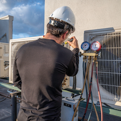 Technician performing AC repair and installation in New Braunfels and San Antonio, TX