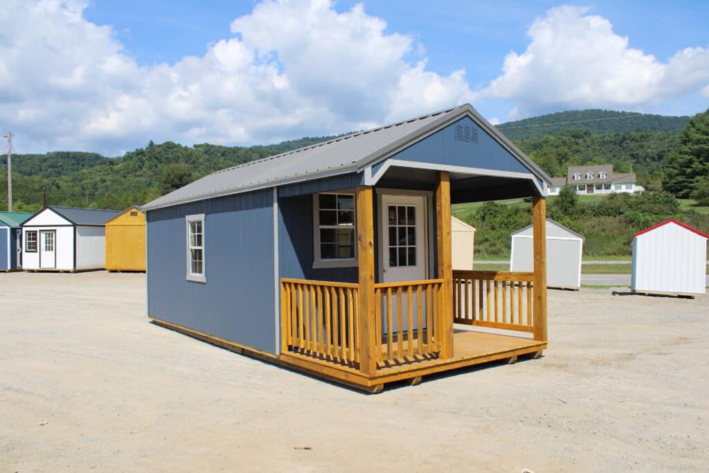 An old barn with a red barn in the background