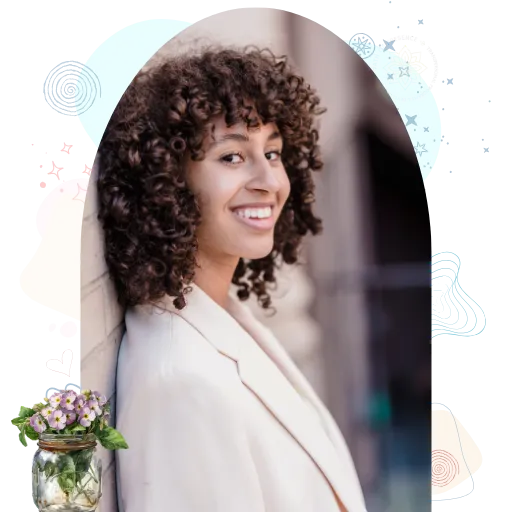 A Smiling girl with curly hair in a white blazer
