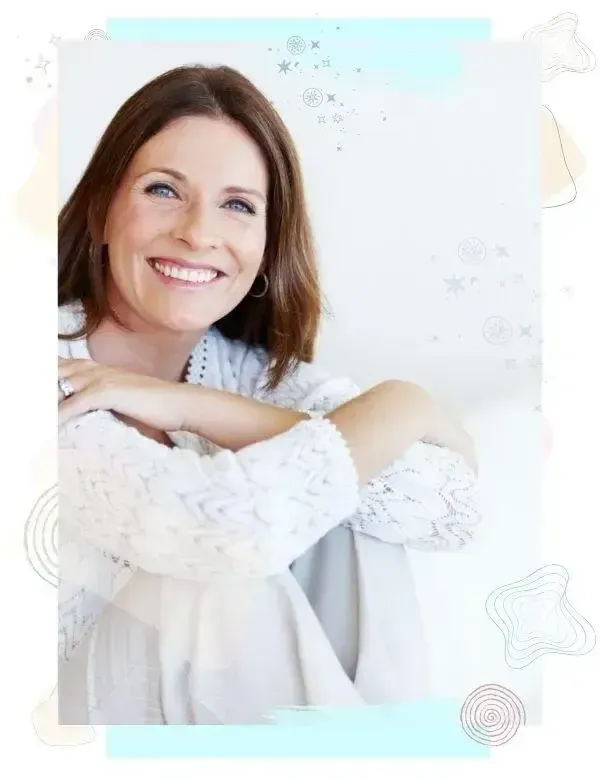 Woman sitting peacefully with a gentle smile, representing inner ease, self-trust, and aligned prosperity.