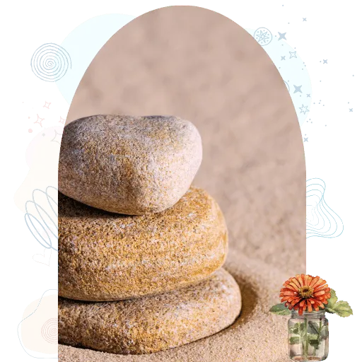 Stacked stones in sand representing a calm, grounded container for integration circles