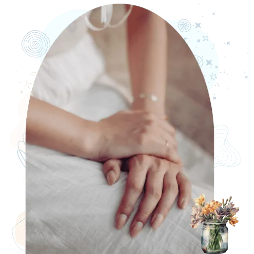 Hands resting gently on fabric in a quiet moment of embodied presence and stillness.