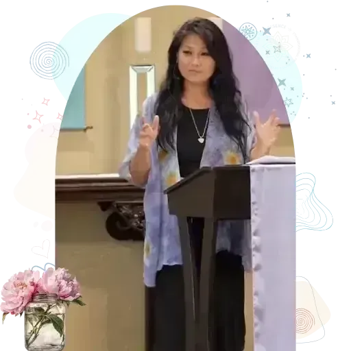 Woman standing at a podium with hands gesturing