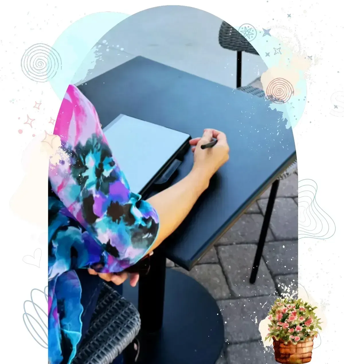 Person writing in notebook at outdoor table with abstract digital effects and graphics overlay