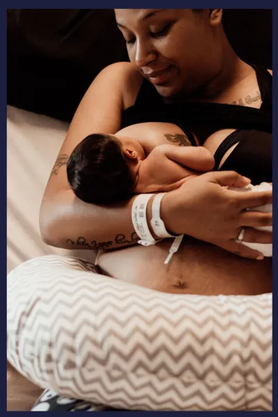 Image of a baby being breastfed by its mother, shortly after being born by. Image corresponds with a list of what is included in private birth education classes in Minneapolis and Saint Paul, Minnesota.