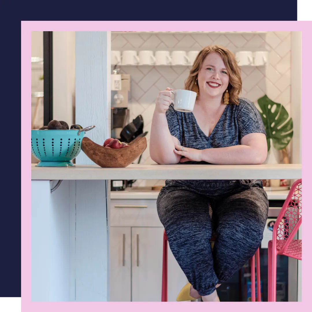 A picture of Twin Cities doula, Jillian Carpenter, drinking coffee and smiling at a location in Minneapolis, Minnesota.