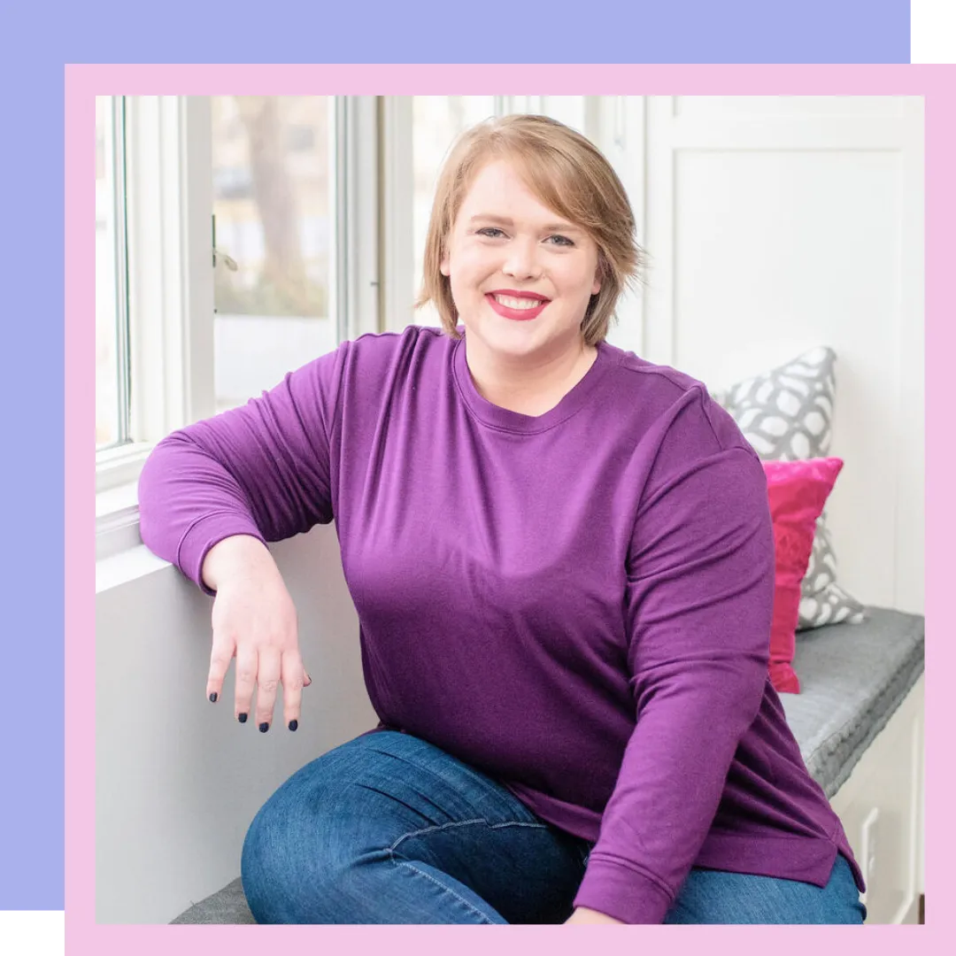 Image of fertility coach, Jillian Carpenter, smiling at the camera with a white kitchen behind her.