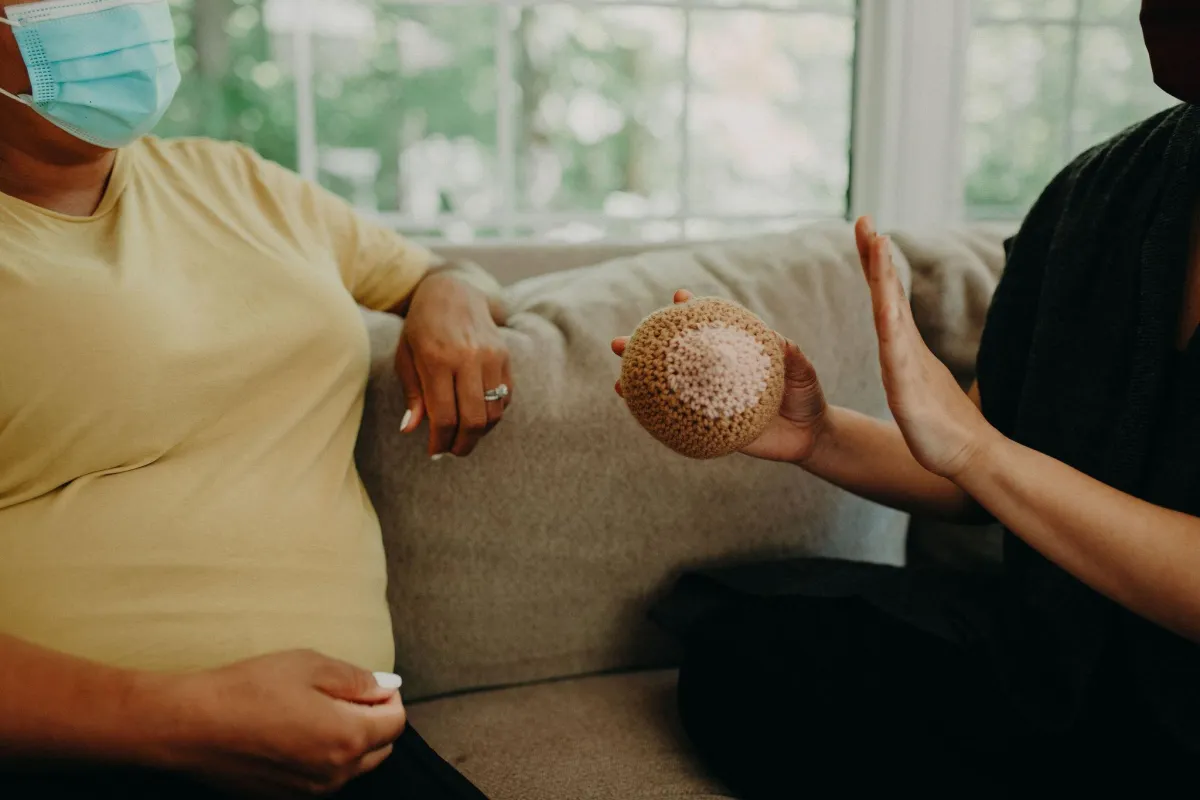 An IBCLC teaches a pregnant person about lactation during a prenatal lactation consultation