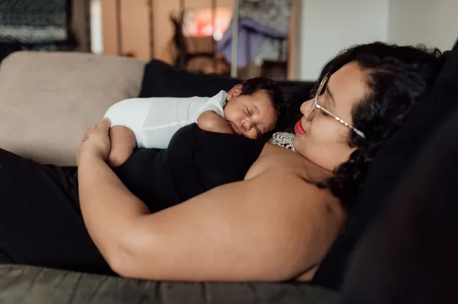 A new mother does skin to skin with her newborn on her chest