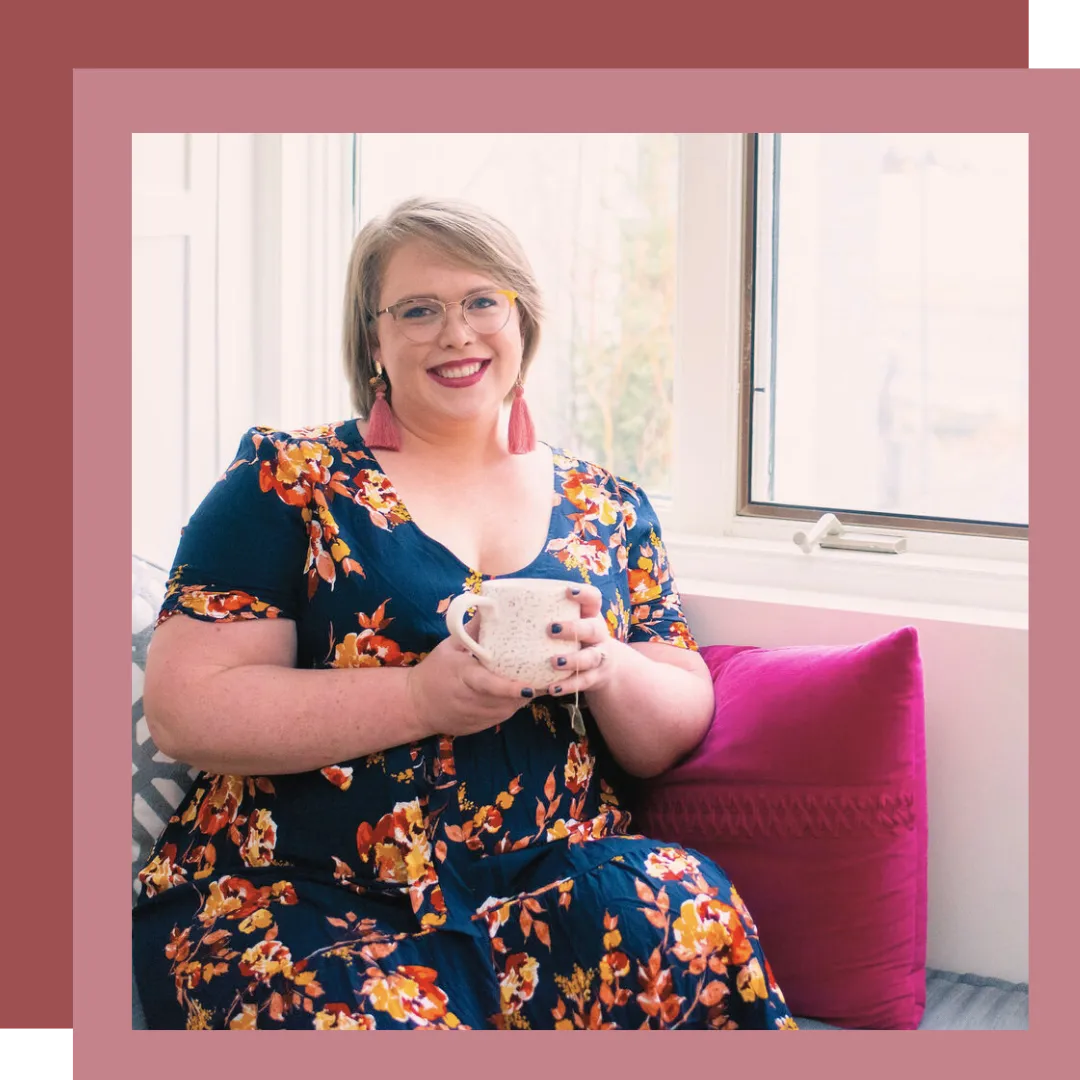 A picture of Twin Cities doula, Jillian Carpenter, drinking coffee and smiling at a location in Minneapolis, Minnesota.