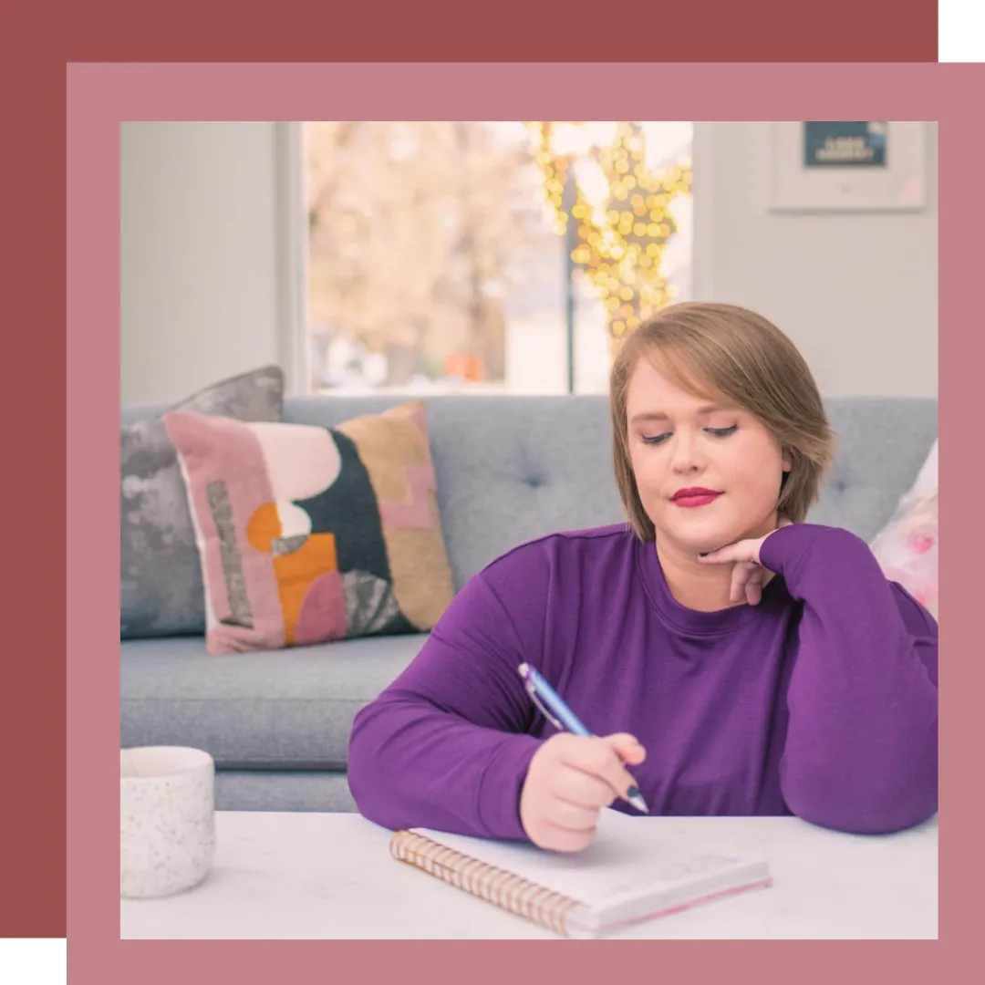 Image of fertility coach, Jillian Carpenter, smiling at the camera with a white kitchen behind her.