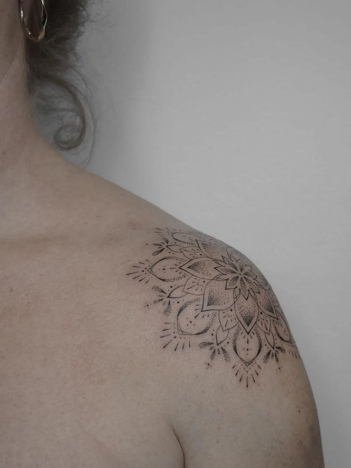 person in blue denim shorts and white nike sneakers standing on gray concrete floor