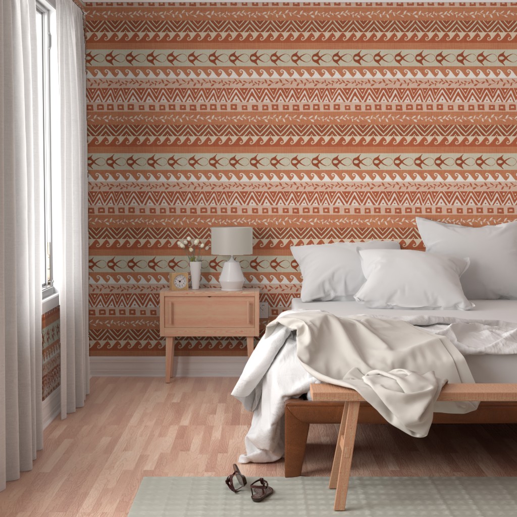 Warm terracotta and cream Southwest-inspired geometric stripe wallpaper used as a bedroom feature wall with a layered, earthy palette.