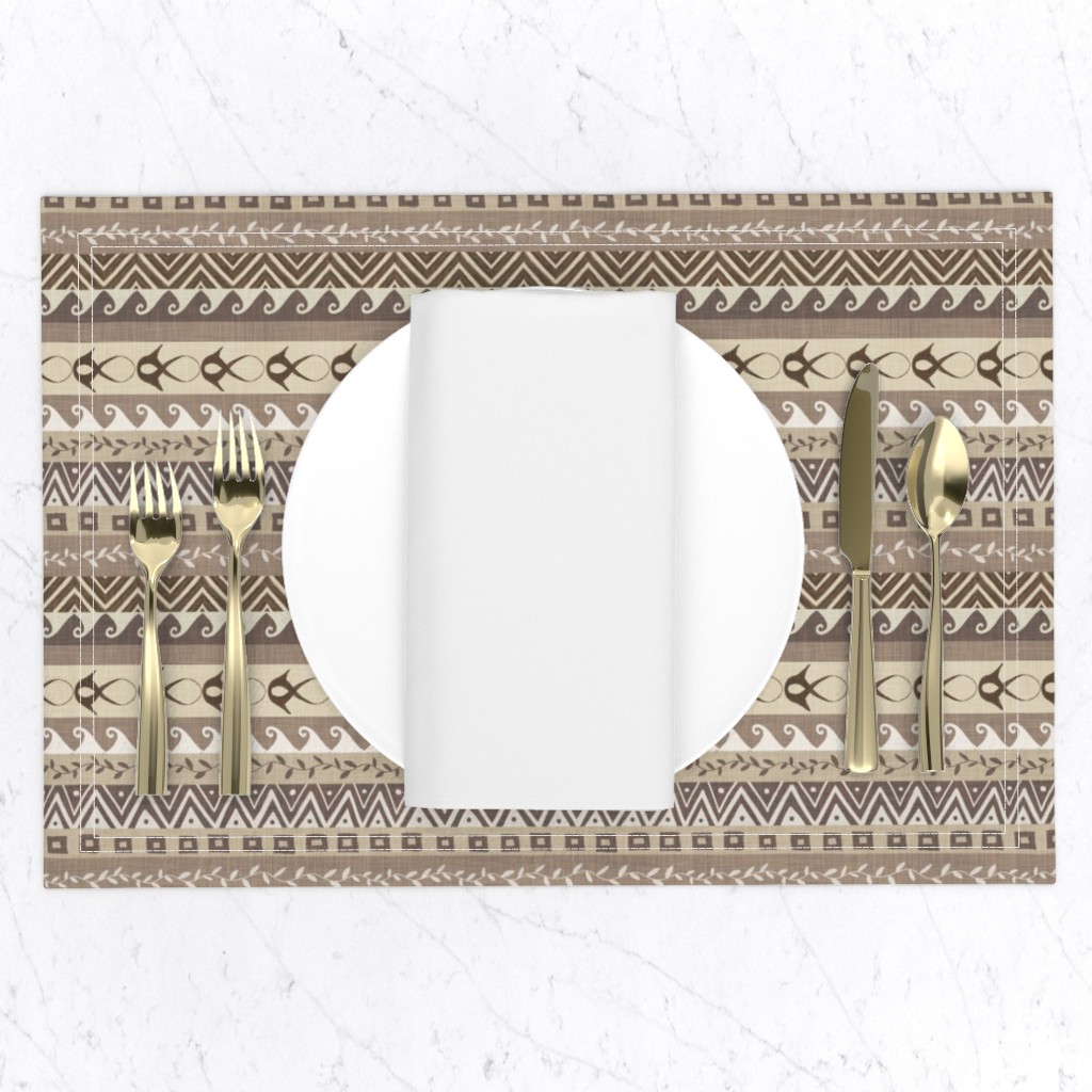 Muted taupe and cream geometric stripe placemats with tribal-inspired bands, layered for a neutral dining table setting.