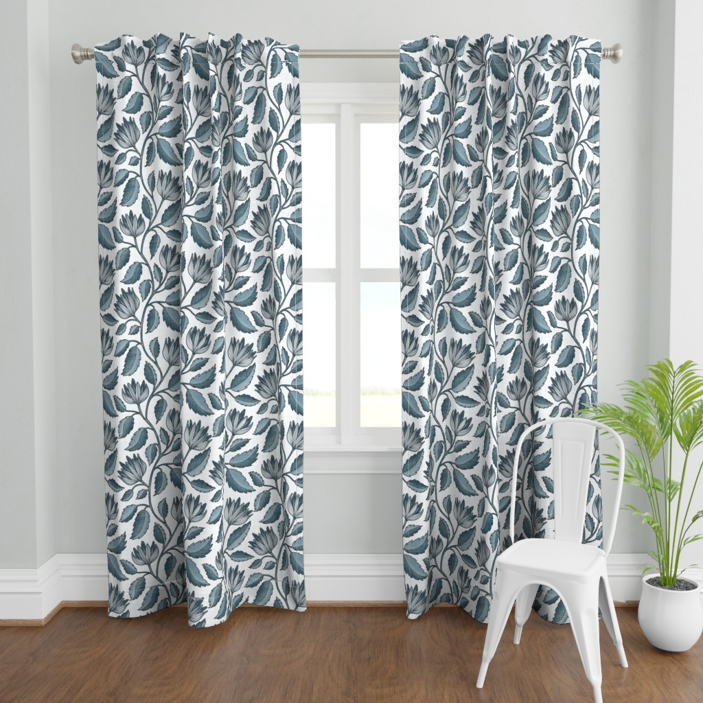 Blue hand drawn botanical floral curtains with leafy vines and outlined flowers, styled in a bright room with a window and white chair.