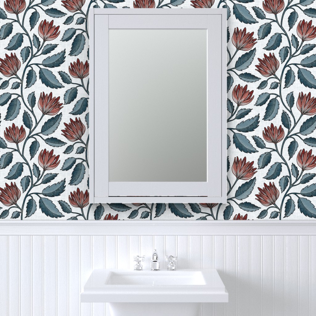 Hand drawn botanical floral in rust red and blue green on white, shown as bathroom wallpaper above white beadboard and sink.