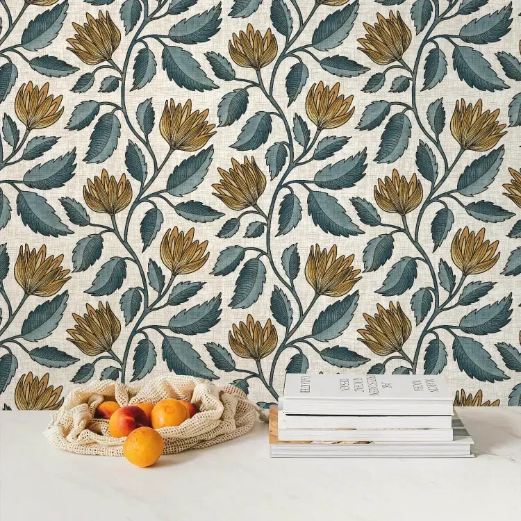 Teal blue and ochre hand drawn floral wallpaper with leafy vines on a cream textured wall.