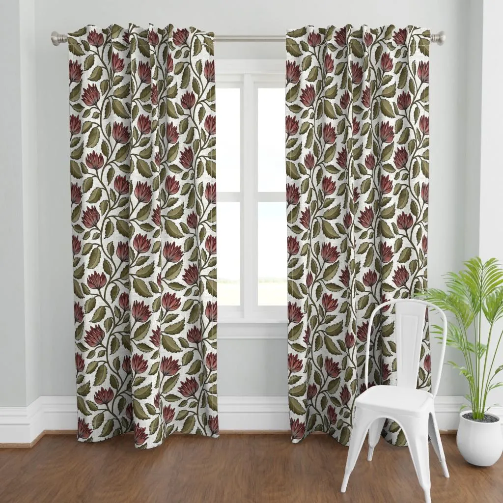 Muted botanical floral curtains with red blooms, olive leaves, and a cream ground, shown in a light room with layered home decor styling.