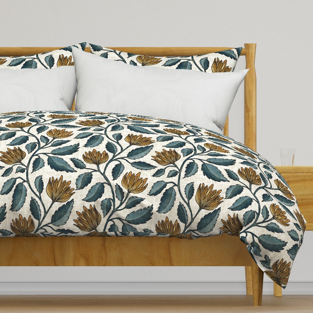 Arts and Crafts style botanical floral bedding with ochre blooms and muted teal leaves, styled on a wooden bed for a layered bedroom decor look.