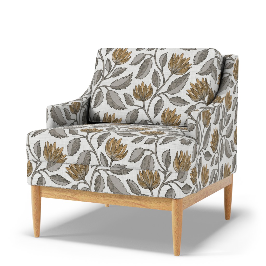 Gray and ochre botanical floral upholstery on an accent chair with wood legs.