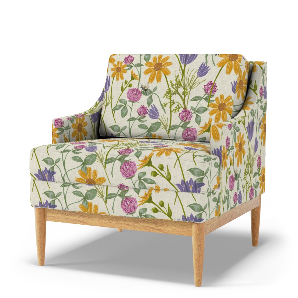 Yellow daisy, purple wildflower, and green botanical print on a linen-look upholstered accent chair.