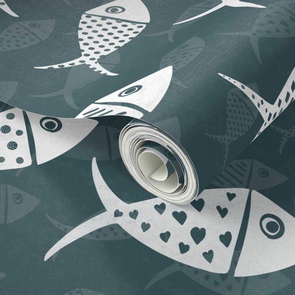 Dark teal Nautical School of Fish wallpaper shown as a rolled sample with white hand-drawn fish and tonal fish silhouettes.