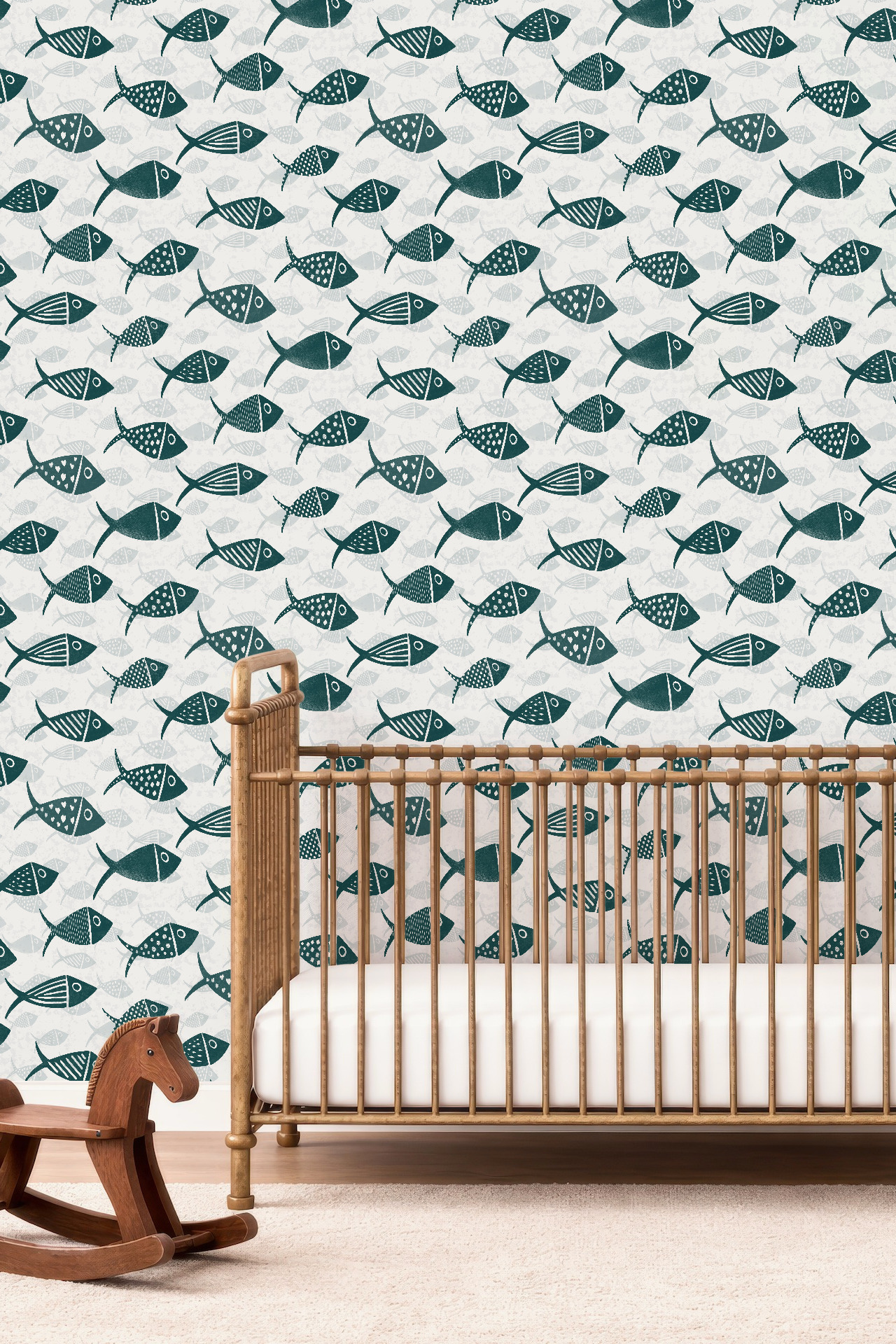 Teal and white Nautical School of Fish wallpaper in a nursery with a wooden crib and layered hand-drawn fish repeat.