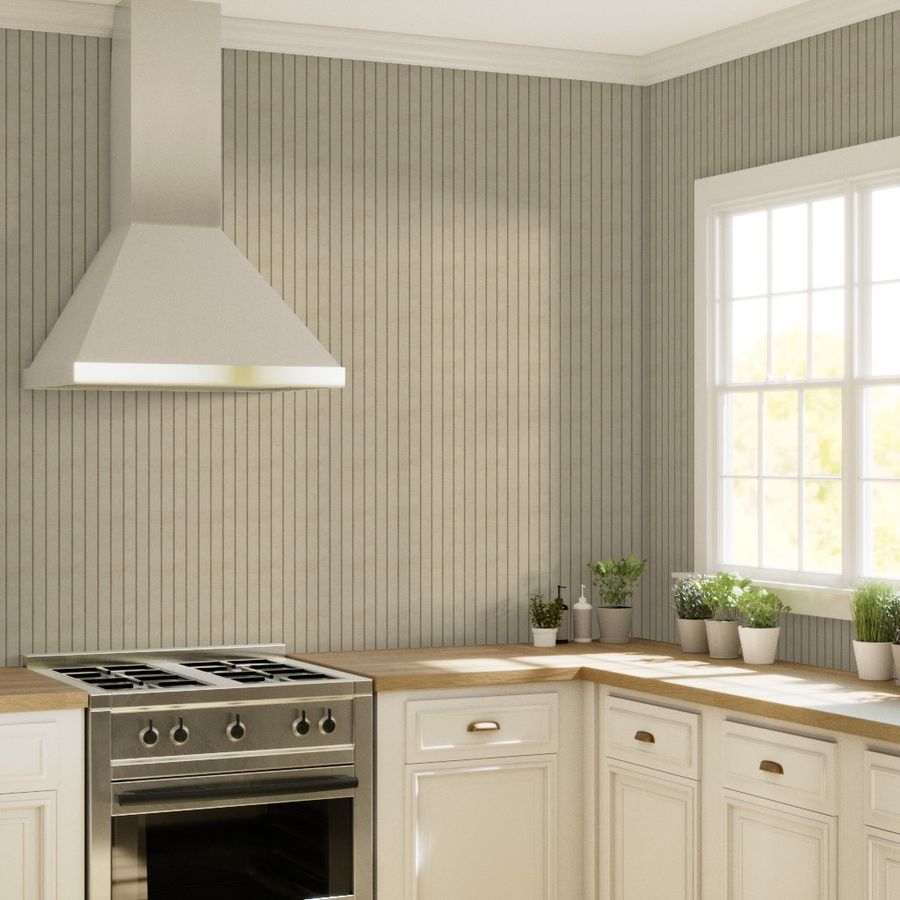 Warm taupe wallpaper with slim dark vertical stripes in a kitchen with a white range hood, window and cabinetry.