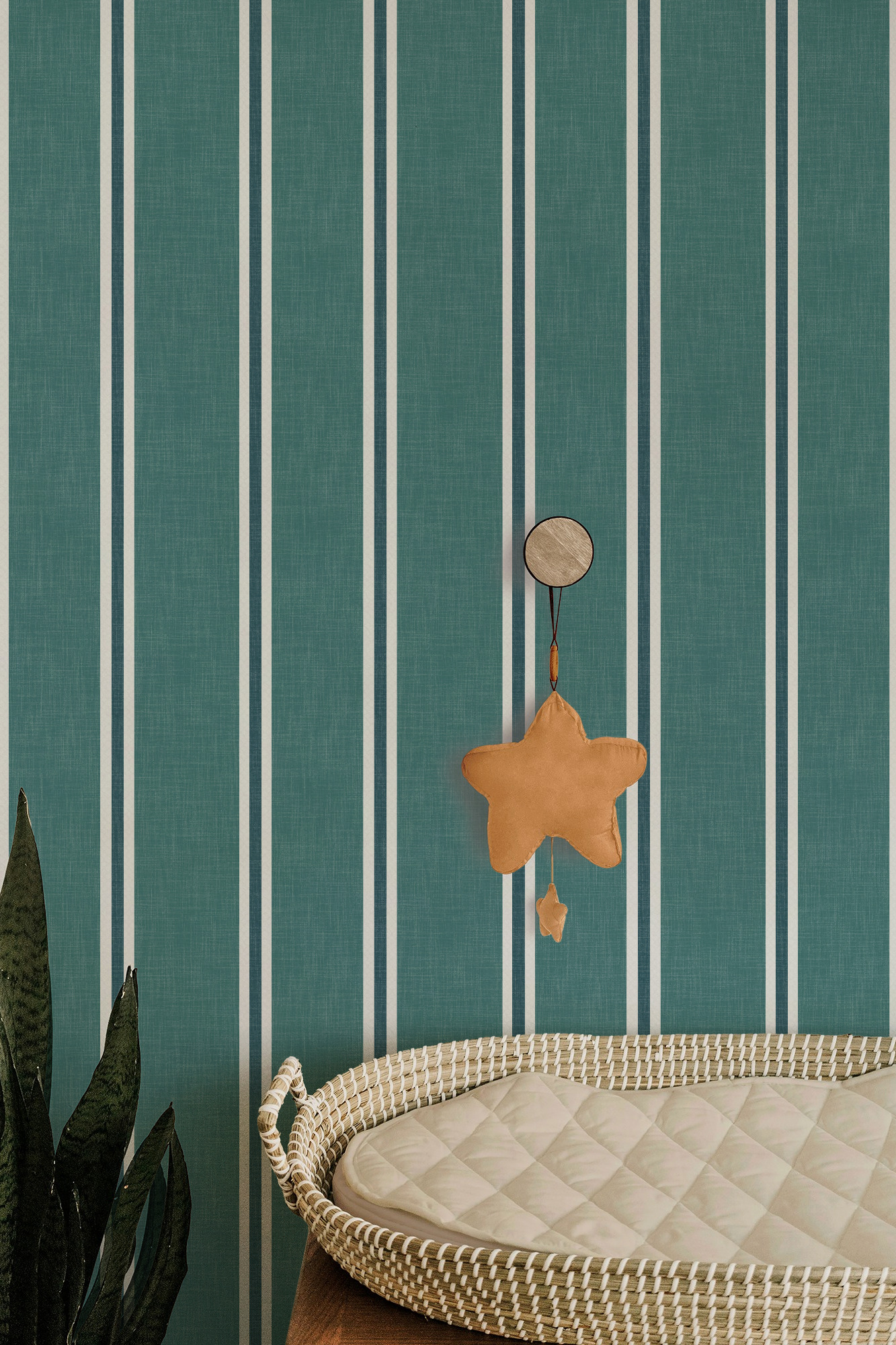 Dark teal Nantucket Linen Textured Stripe wallpaper in a nursery setting with a hanging star decoration and fine light vertical stripes.