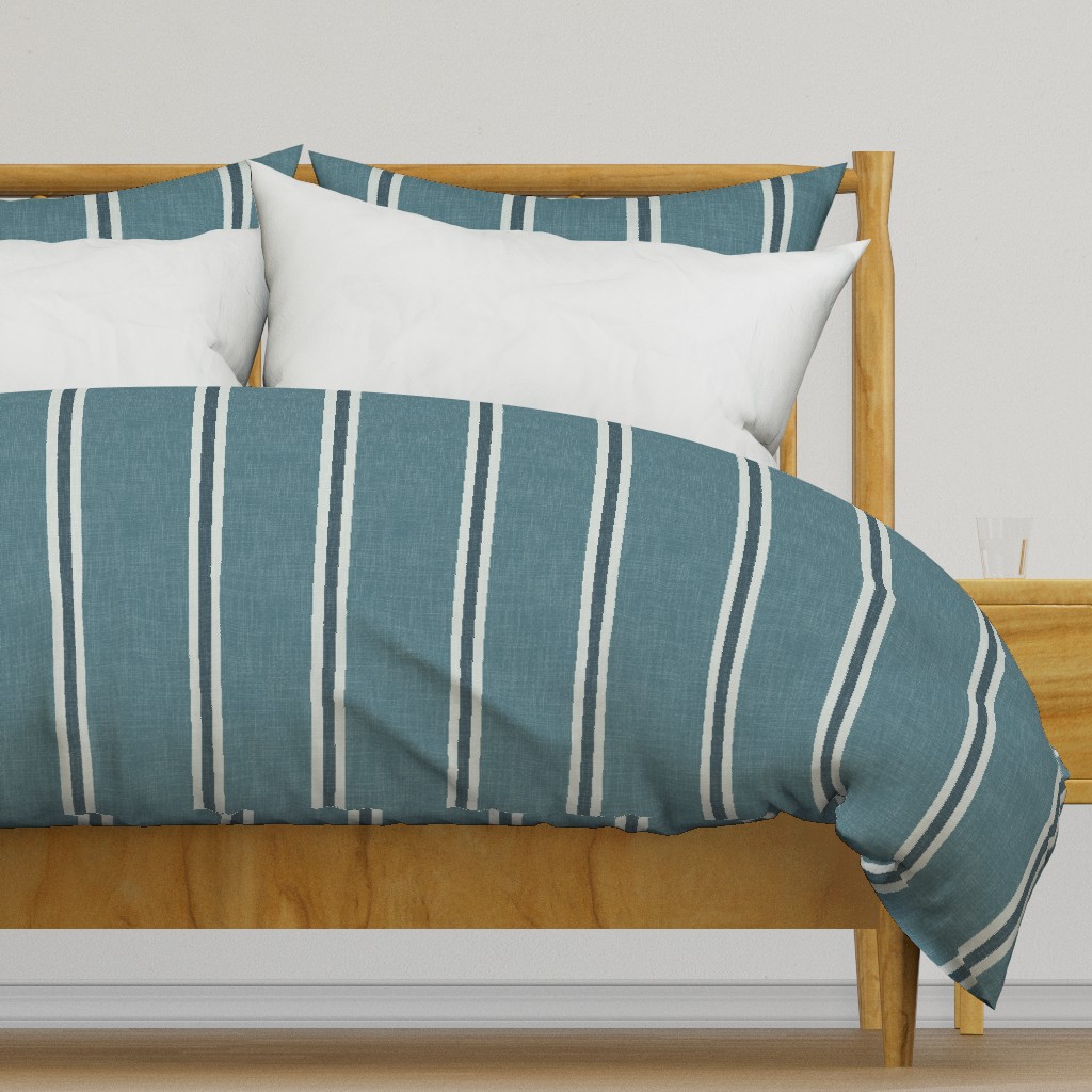 Blue Nantucket Linen Textured Stripe design on a duvet cover and pillow shams with broad blue bands and fine light stripes.
