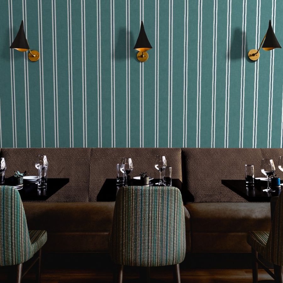 Teal Nantucket Linen Textured Stripe wallpaper by Roselk Design in a restaurant dining area with banquette seating and black and brass wall lights.