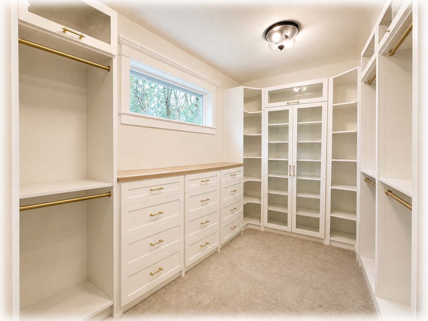 Custom walk-in closet with built-in shelving and drawers designed for new homes.