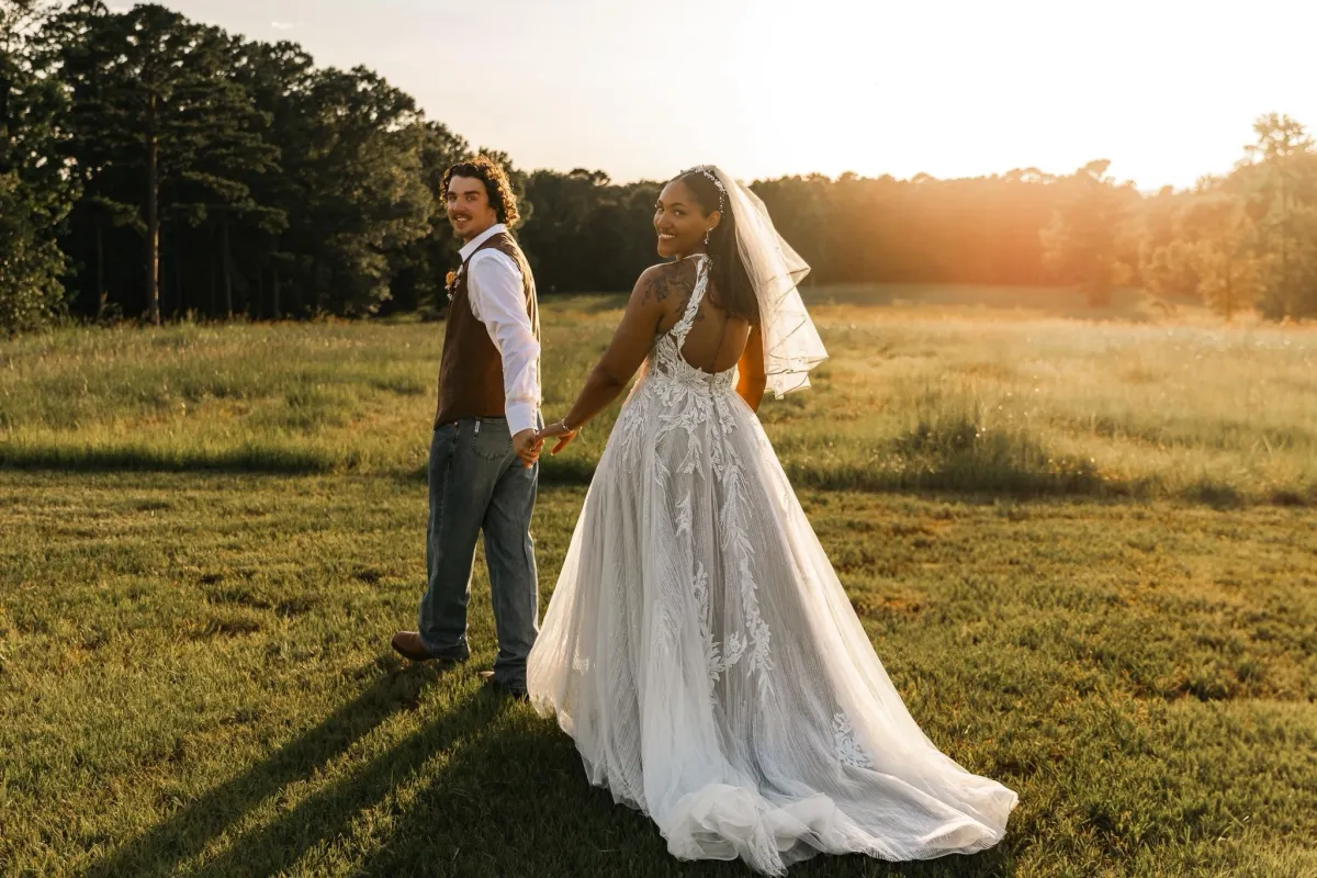 bride and groom walking at sunset venue in texas