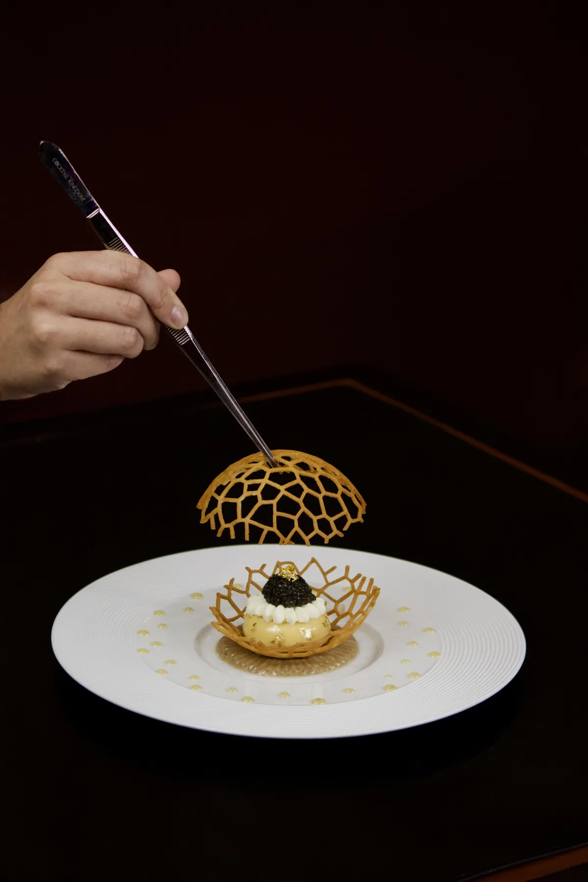 A softly lit, elegantly set table for two at Lucie, featuring crisp white linens, delicate glassware, and a single candle, with muted ivory and grey tones creating a tranquil, inviting atmosphere. No people are present, emphasizing calm anticipation.