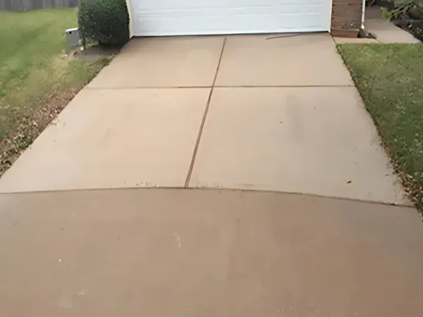 Driveway after professional pressure washing, looking spotless and renewed