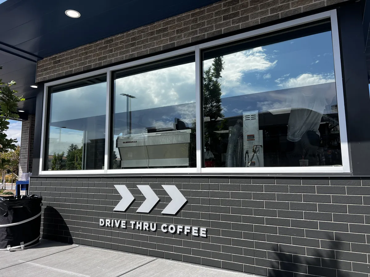 Commercial window tint installed on a 7 Brew drive-thru coffee stand in Northern Colorado
