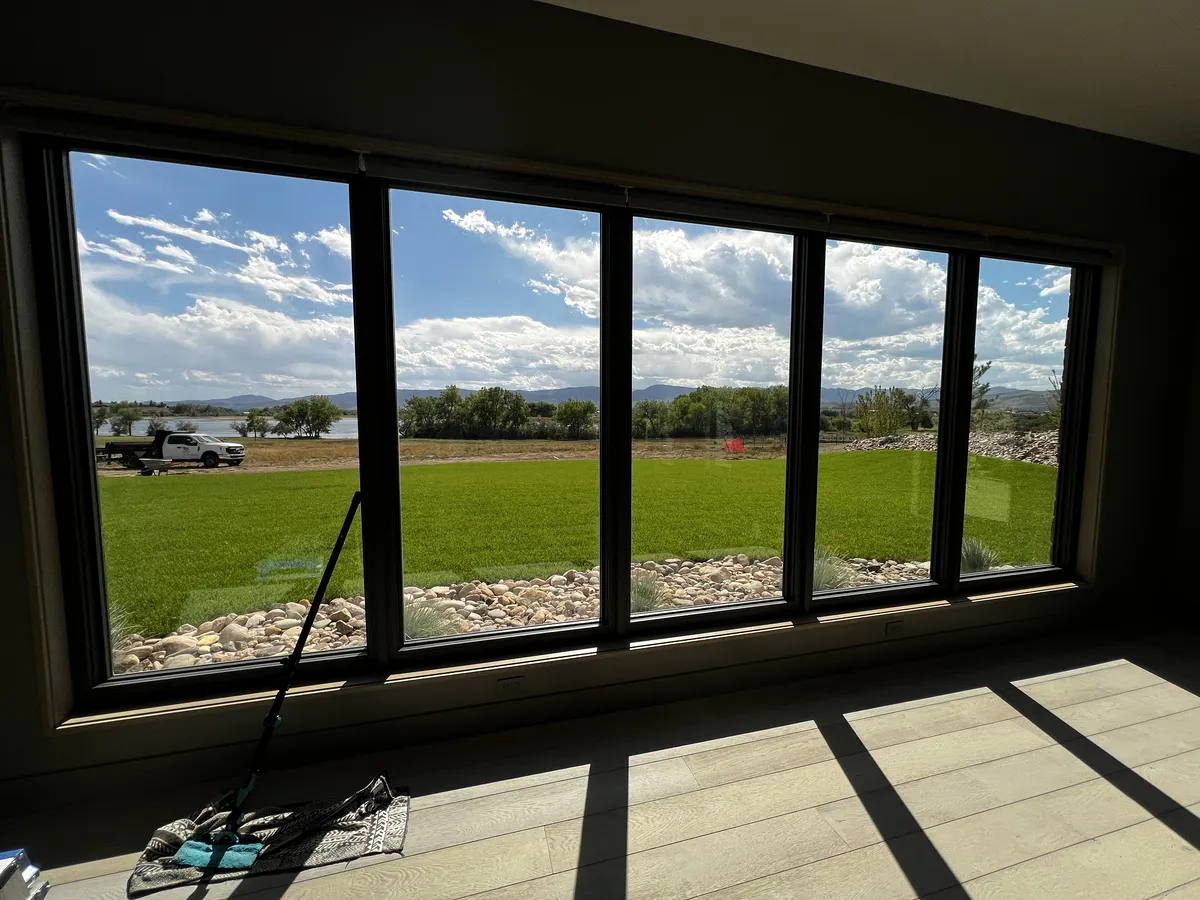 Post-construction window cleaning on new windows overlooking open fields in Fort Collins, CO