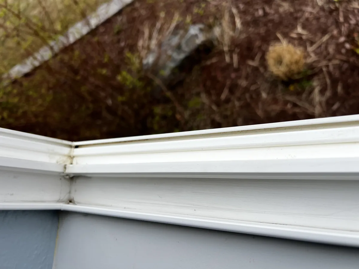 Clean white window tracks after professional track cleaning