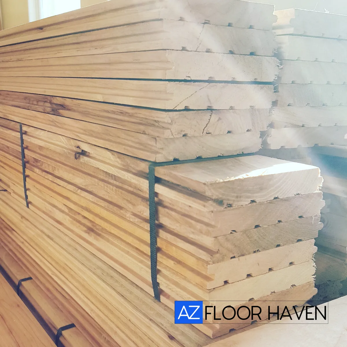 Neatly stacked bundles of premium raw hardwood planks ready for a custom wood flooring installation in Tucson Arizona