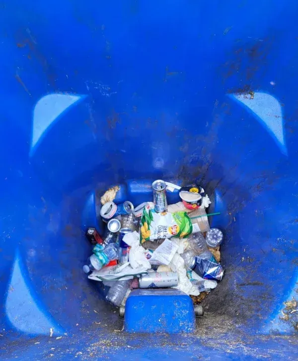 A close-up, abstract view of a blue plastic molded surface with a circular recess and geometric shapes.