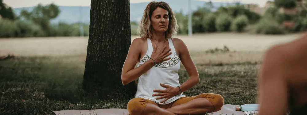 Woman practicing somatic breathwork in peaceful environment