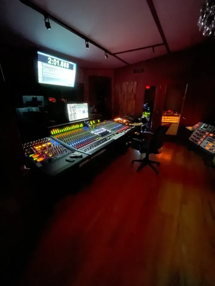 woman in black sweater holding white and black vr goggles