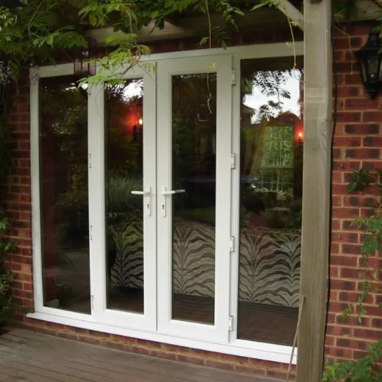 A white double door featuring a central glass panel, providing a view through the entrance.